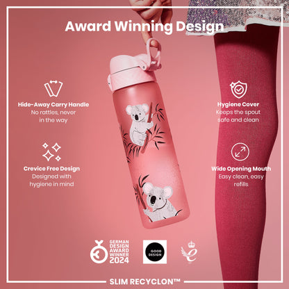 A pink water bottle, featuring koala illustrations, is held. Its design prioritizes hygiene and ease of use; it boasts a hide-away handle, crevice-free construction, and a wide mouth. The bottle is an award winner.