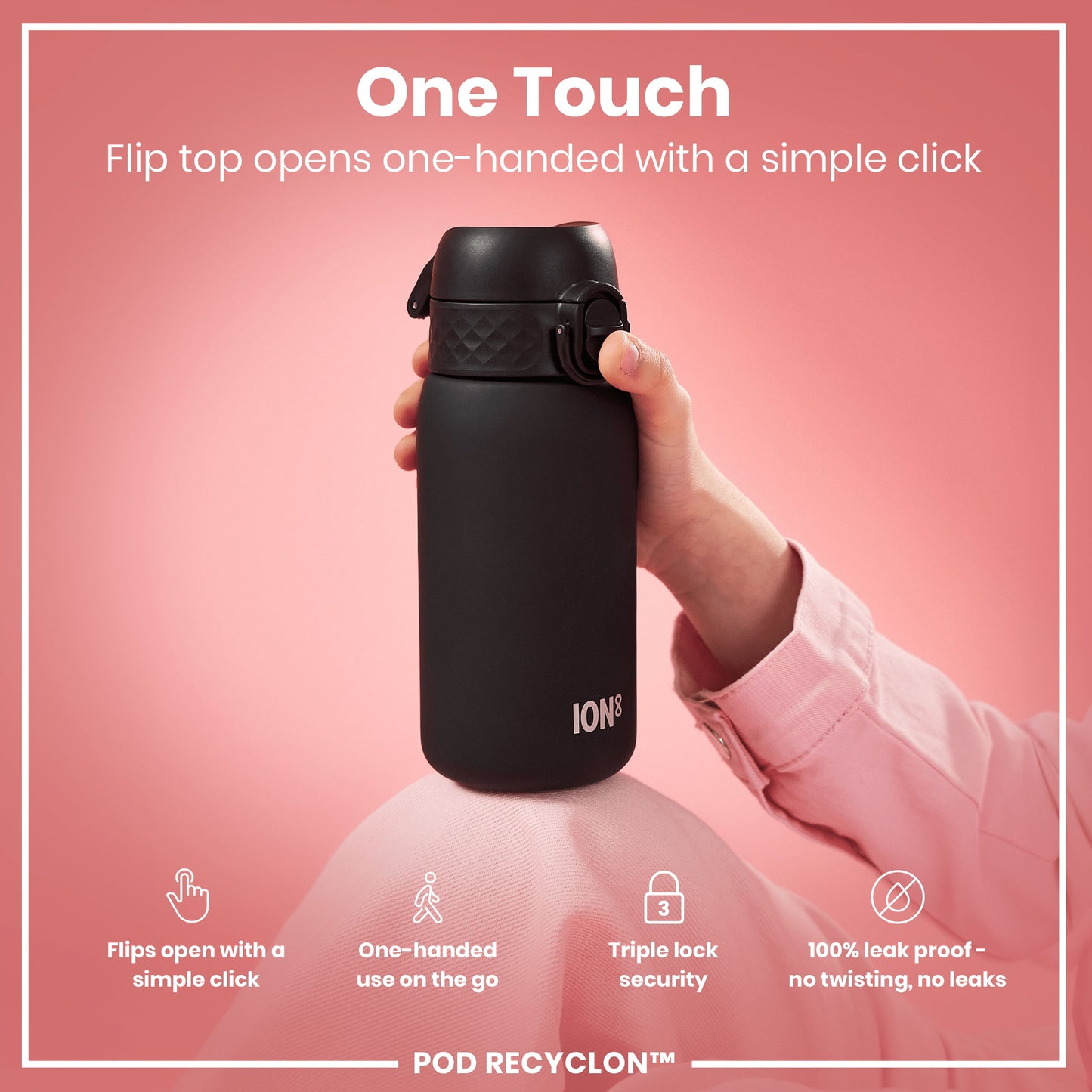 A black ION8 water bottle is being held. Its flip top opens one-handed; the bottle is displayed against a pink background. Flip top opens one-handed with a simple click. Flips open with a simple click. One-handed use on the go. Triple lock security. 100% leak proof - no twisting, no leaks. POD RECYCLON™.