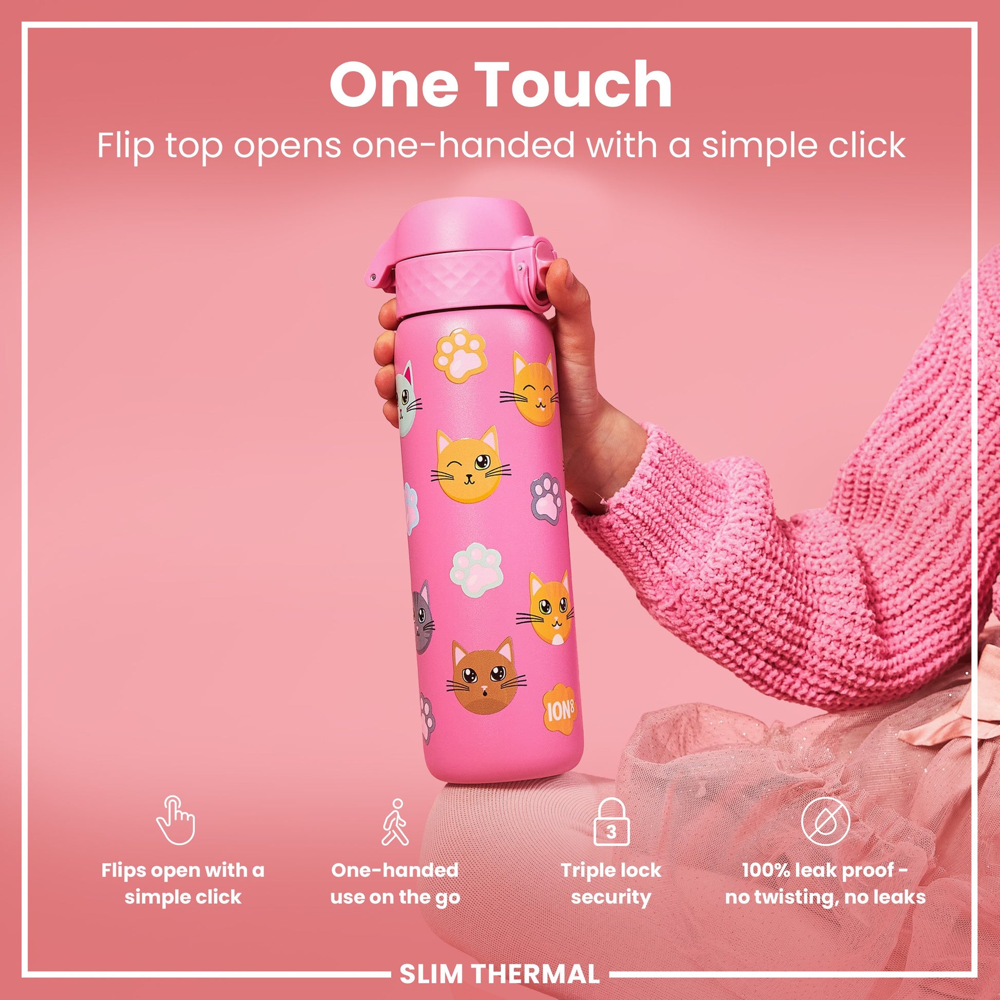 A pink water bottle, decorated with cats, is being held. Its flip top opens one-handed. The bottle is advertised as leakproof and has triple-lock security.