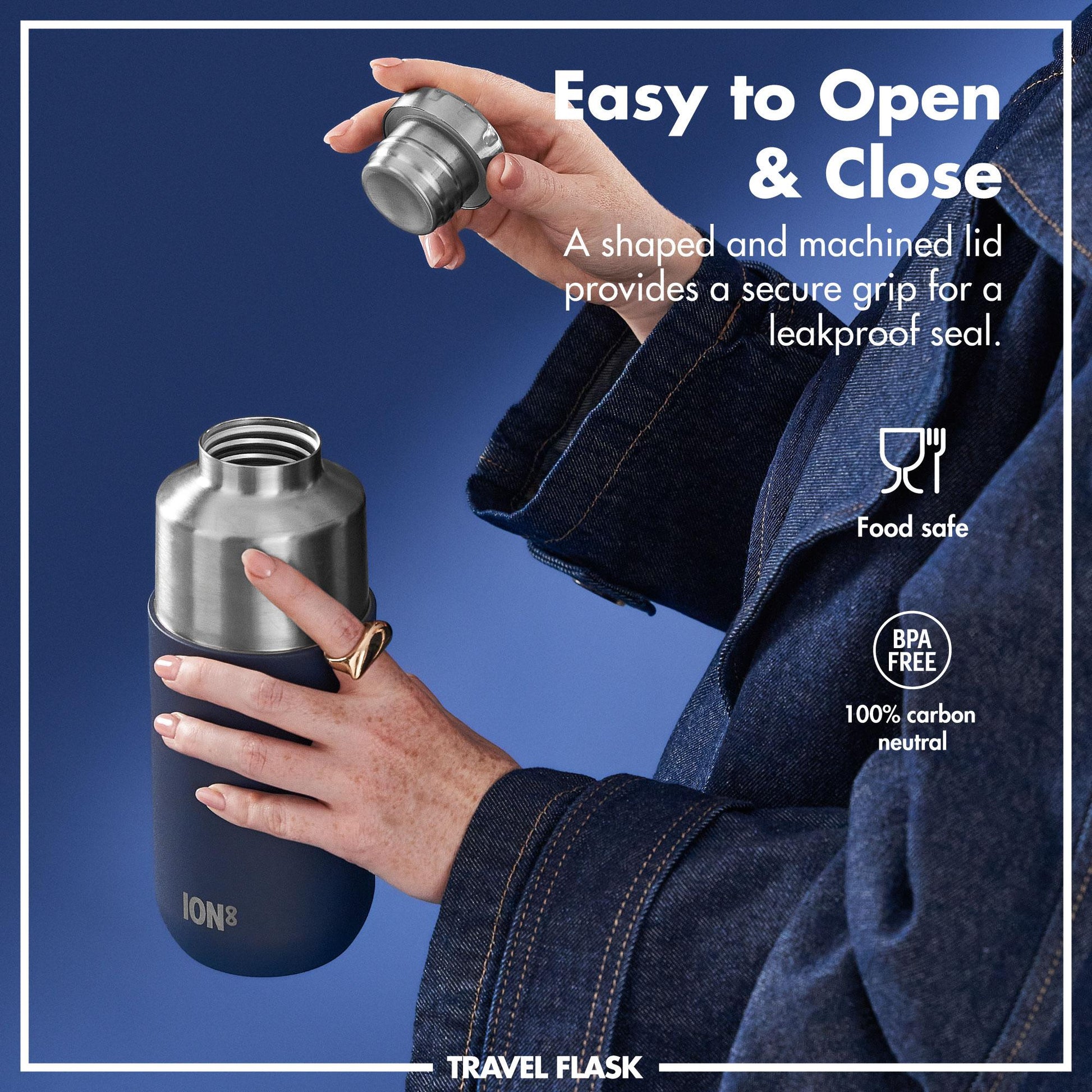 A person holding and opening a stainless steel travel flask against a blue background. Text reads Easy to Open & Close A shaped and machined lid provides a secure grip for a leakproof seal. Food safe BPA FREE 100% carbon neutral. Brand name ION8 TRAVEL FLASK.