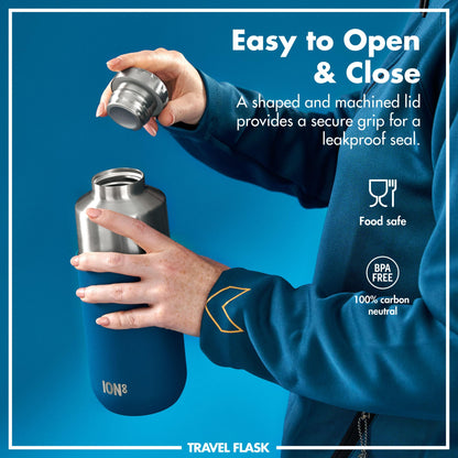 Hands open a metal travel flask with a machined lid surrounded by text: Easy to Open & Close A shaped and machined lid provides a secure grip for a leakproof seal Food safe BPA FREE 100% carbon neutral ION8 TRAVEL FLASK