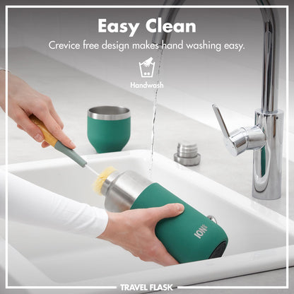 Hands holding a travel flask being cleaned with a brush under a running faucet in a kitchen sink Easy Clean Crevice free design makes hand washing easy Handwash Travel Flask