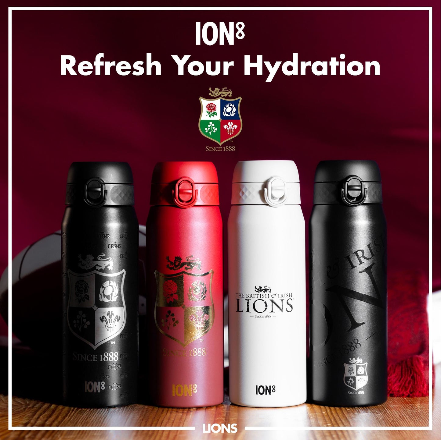 Four insulated water bottles, displaying the British and Irish Lions logo, sit on a wooden surface against a dark red backdrop. ION8 branding is visible. The text reads: "ION8 Refresh Your Hydration SINCE 1888 THE BRITISH & IRISH LIONS SINCE 1888 LIONS".