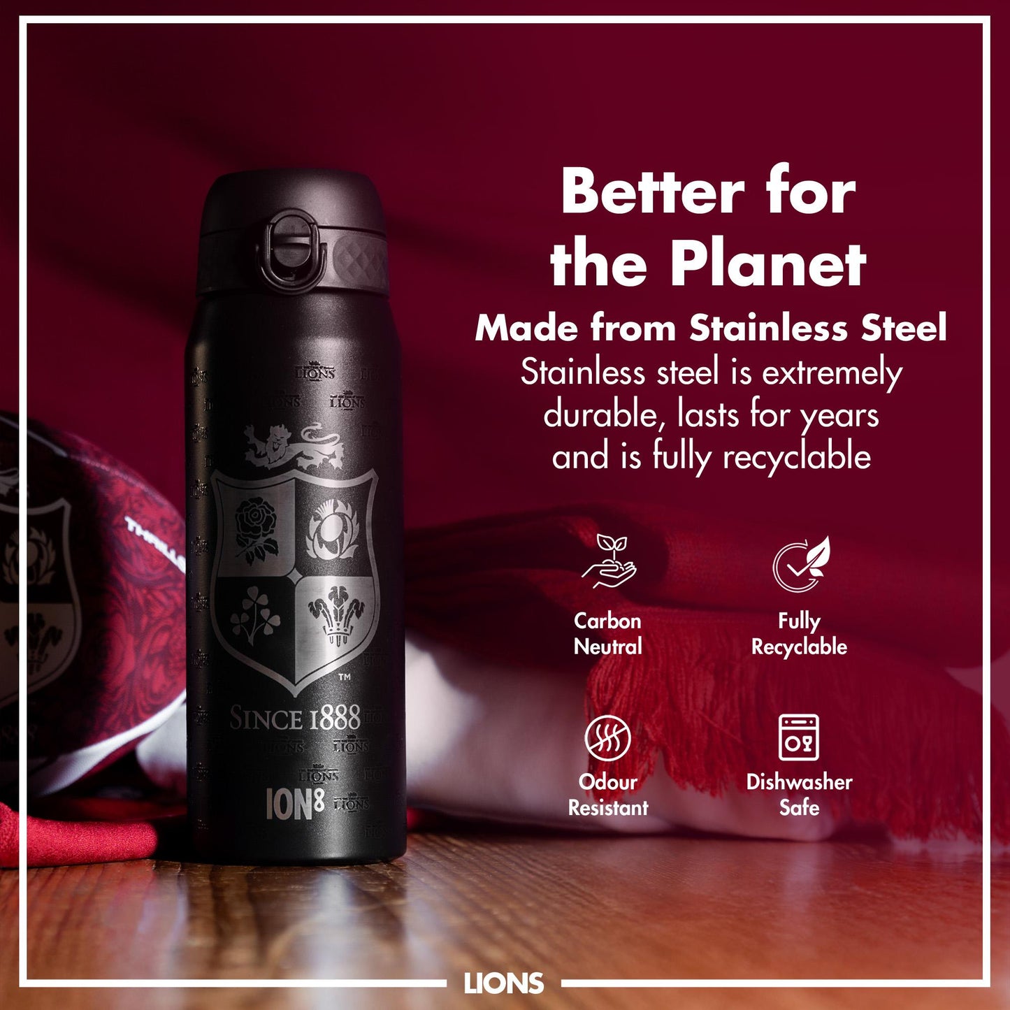 A black, stainless steel water bottle sits on a wooden surface. It features a British and Irish Lions logo and the text "SINCE 1888" and "ION8". The bottle is displayed against a dark red background with promotional text highlighting its sustainability.